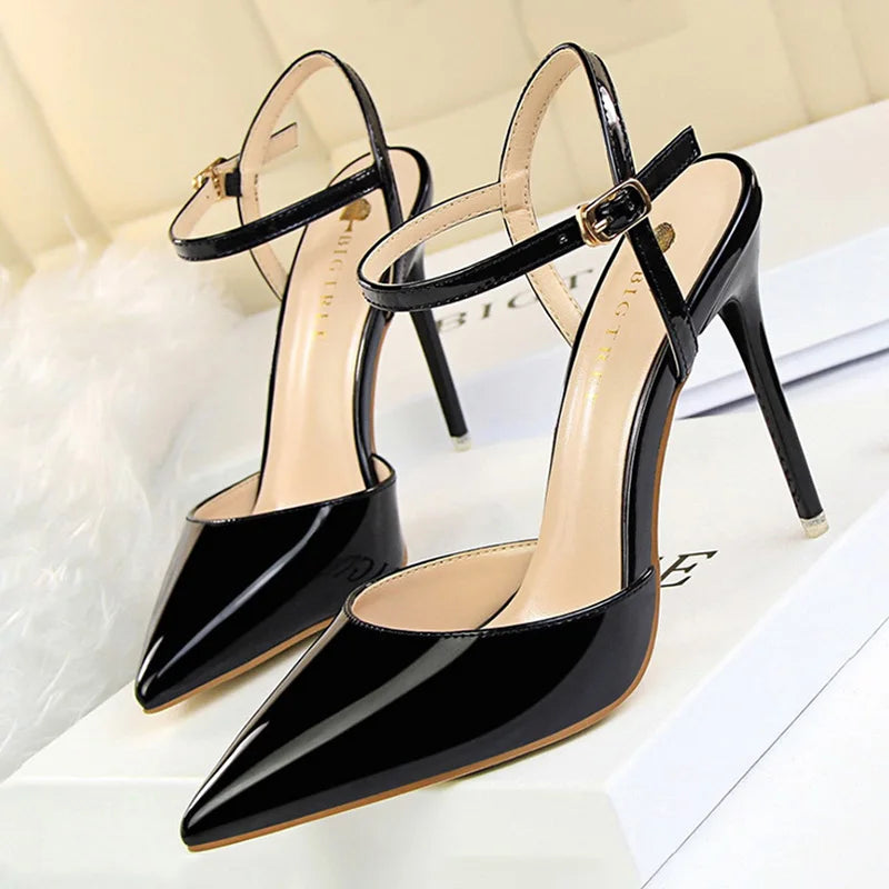 Patent Leather Stiletto Pumps - Women's Pointed Party Heels on display with a shiny black finish and elegant buckle strap.