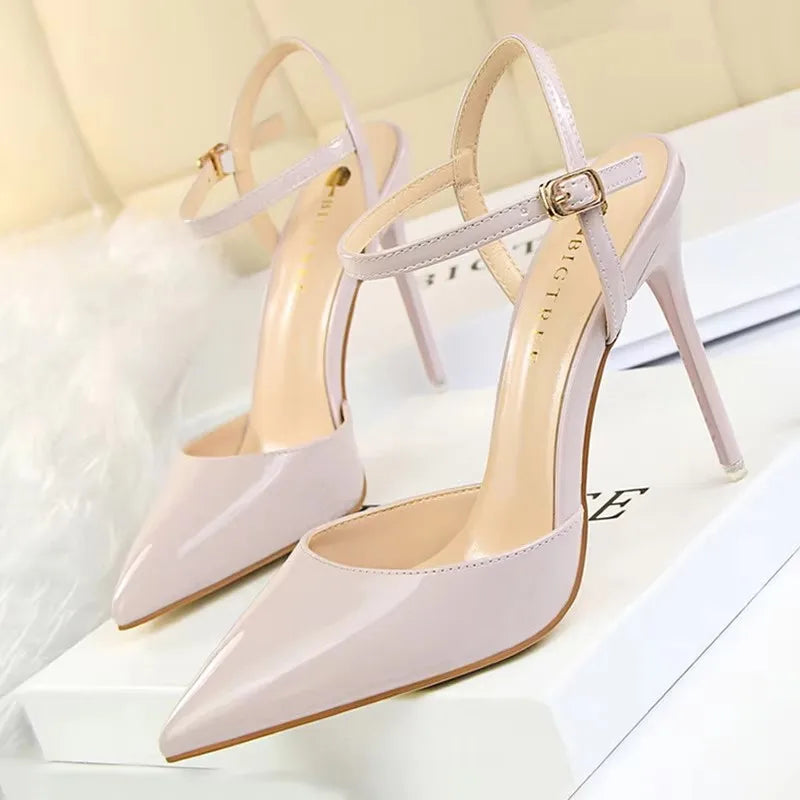 Patent Leather Stiletto Pumps - Women's Pointed Party Heels on display with a shiny black finish and elegant buckle strap.