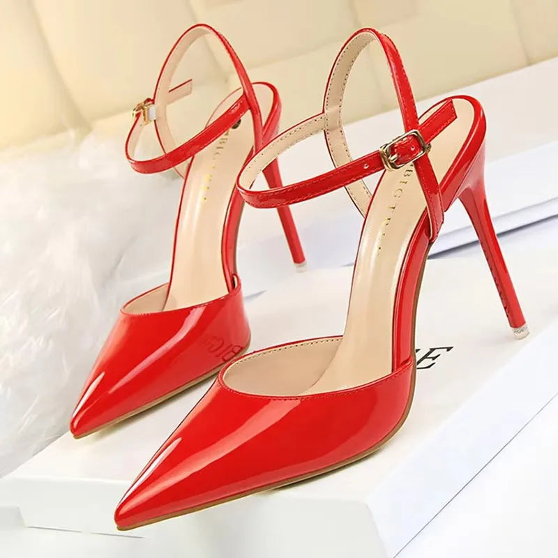Patent Leather Stiletto Pumps - Women's Pointed Party Heels on display with a shiny black finish and elegant buckle strap.